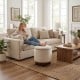 Beige 360° swivel footrest with hidden storage, soft velvet fabric, and sturdy acacia wood frame for versatile living.