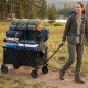 Heavy-duty collapsible wagon cart in black, carrying camping gear, with adjustable handle and all-terrain wheels.