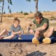 Self-inflating lightweight foam sleeping cot in blue, providing comfort and warmth for outdoor camping.