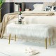 Upholstered faux fur vanity stool with golden legs, perfect for bedrooms or makeup rooms, offering comfort and style.
