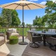 Patio market umbrella base stand with rattan design, 27 lbs, ideal for outdoor use on balconies or by the poolside.