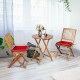 Folding wooden bistro set with red cushioned chairs and round table, perfect for outdoor dining and easy storage.
