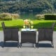 Two patio wicker chairs with cozy seat cushions, set on a lawn, ideal for outdoor relaxation by the poolside.