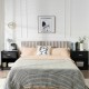 Black nightstand with storage drawer and open compartment, perfect for bedside or living room use, featuring a modern.