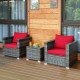 Patio rattan sofa set with red cushions, featuring a tempered glass table, perfect for outdoor relaxation.