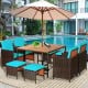 9-piece patio dining set with turquoise cushioned chairs and acacia wood tabletop, perfect for outdoor use by the pool.