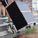 Portable folding stair climbing hand truck with three-wheel design, adjustable handle, and elastic rope for secure.