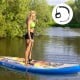 Inflatable stand-up paddle board with adjustable aluminum paddle, suitable for water activities like yoga and fishing.