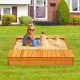 Kids playing in a cedar sandbox with storage boxes, perfect for outdoor creativity and collaboration in the backyard.