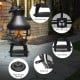 Patio wood burning chiminea fireplace with round wire mesh fire cage, solid iron legs, and heat shield for outdoor use.