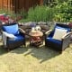 Two blue-cushioned patio chairs and a wooden coffee table in a garden setting, perfect for outdoor relaxation.