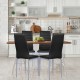 Four black PVC leather dining side chairs with painted steel legs around a wooden table in a modern kitchen setting.