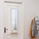 Wall door-mounted mirrored jewelry cabinet in white with full-size mirror, featuring organized storage for jewelry and.