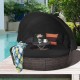 Round outdoor daybed with retractable canopy in black, featuring soft cushions and adjustable table for patio.
