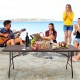 6 feet folding portable rattan table with carrying handle, set for outdoor dining, featuring a pastoral weave design.