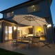 Beige 10 ft solar-powered LED patio offset umbrella with 360° rotation, perfect for outdoor dining and relaxation.