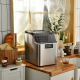 Electric portable countertop ice maker in silver, producing 24 square ice cubes per cycle for convenient summer cooling.