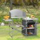 Foldable outdoor BBQ grilling table in gray with windscreen, side tables, and storage bag, ideal for camping and.
