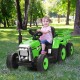 Child riding a green 12V ride-on tractor with detachable trailer, designed for fun and safe outdoor play.