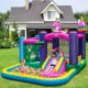 Unicorn-themed 6-in-1 inflatable bounce house with slide and ball pit, perfect for kids' outdoor playtime.