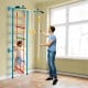 Kids indoor gym playground featuring a wall ladder, pull-up bar, and gymnastic rings for active play and fitness.