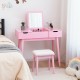 Pink makeup vanity table set with flip-top mirror, 2 drawers, and cushioned stool for stylish bedroom storage.