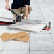 Manual tile cutter with sharp tungsten carbide blade, ergonomic handle, and adjustable side brackets for precise.