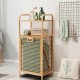 Tilt-out bamboo laundry hamper with removable liner and 2-tier shelf for bathroom or bedroom storage.