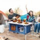 Height adjustable blue folding camping table with storage, perfect for outdoor picnics and barbecues.