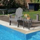 Gray outdoor Adirondack chair with built-in cup holder, placed poolside for comfortable backyard relaxation.