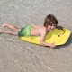 Child riding a bright yellow Super Lightweight Surfing Bodyboard in shallow water, perfect for summer water sports.