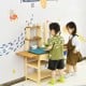 Kid's outdoor wooden pretend cook kitchen playset made of natural fir wood, ideal for imaginative play in the garden.