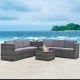 Gray 8-piece wicker sofa rattan dining set with storage table, ideal for outdoor relaxation by the sea.