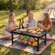 Folding picnic table with large storage net, adjustable height, and sturdy design, perfect for outdoor gatherings.