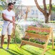 Three-tier wooden vertical raised garden bed with storage shelf, ideal for flowers and vegetables, shown in a garden.