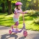 Child riding a purple 3-wheel scooter with LED light-up wheels, designed for stability and safety for kids age 2+.