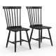 Two black Windsor chairs with high spindle backs and wide seats, designed for comfort and style in dining settings.