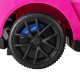 Close-up of a black tire with blue accents from the pink Maserati licensed 3-in-1 ride-on push car for kids.