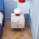 White nightstand with two drawers and solid rubberwood legs, perfect for organizing essentials in a modern bedroom.