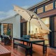 Beige 9' solar LED lighted patio umbrella with tilt adjustment, crank lift, and durable polyester fabric for outdoor.