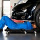 Mechanic creeper with padded headrest and tool trays, foldable design for easy storage, supports up to 350 lbs.