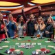 Close-up of the felt surface on a foldable 48-inch poker table, featuring organized chip trays and cup holders for 8.
