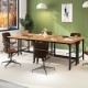 Office setting featuring a 48-inch rolling computer desk with a natural wood top and stylish brown chairs for.