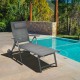 Gray patio reclining chaise lounge with adjustable neck pillow, perfect for outdoor relaxation by the poolside.