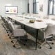 Adjustable gray office chair with armrest, featuring a modern design and 360° swivel for comfortable meetings.