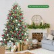 7 feet artificial Christmas tree with 1260 mixed PE and PVC tips, set up in a cozy living room with gifts underneath.