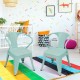 Set of 2 stackable green steel armchairs for kids, featuring ergonomic backrests and rounded corners for safety.