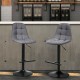 Gray linen bar stool with a modern design, height-adjustable and padded for comfort, ideal for stylish kitchen spaces.