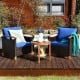 Two blue cushioned patio chairs with a solid wood frame and a coffee table, perfect for outdoor relaxation.
