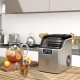 Electric portable countertop ice maker in silver, producing 24 square ice cubes per cycle for home or office use.